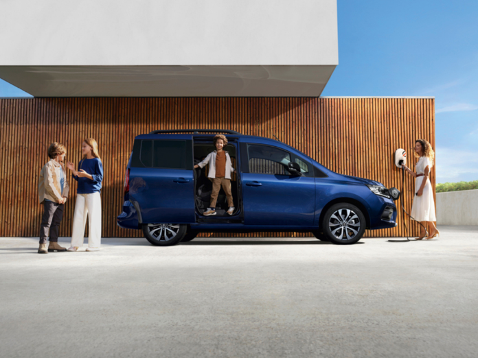 Family with blue Renault Kangoo and mobilize charger on concrete floor with wooden vertical slat background style house